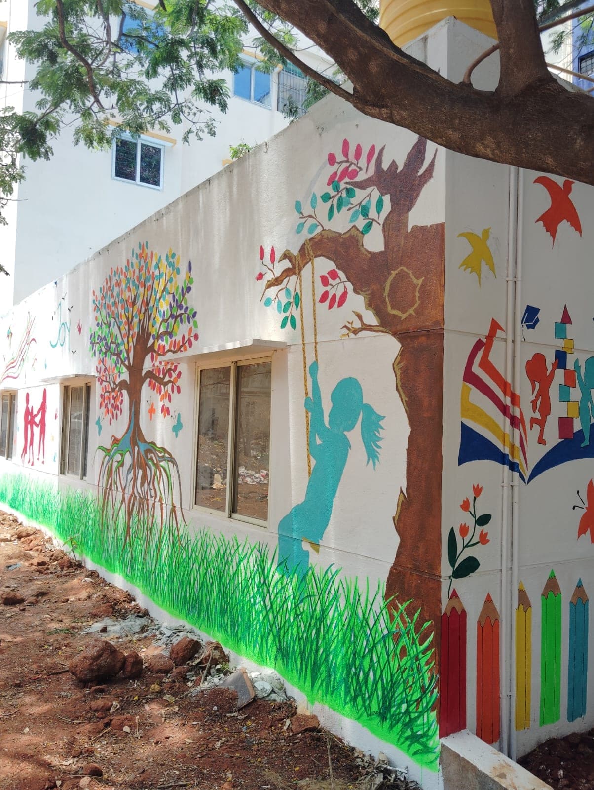 Hand-painted tree and swing mural
